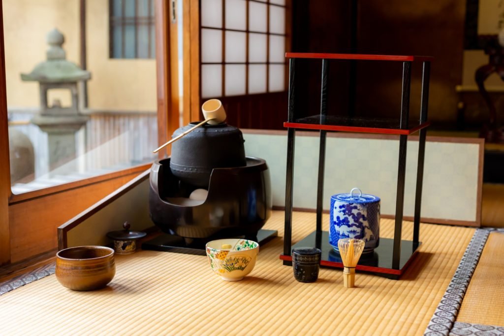Iron kettle on the sunken hearth with matcha bowl and chashaku
